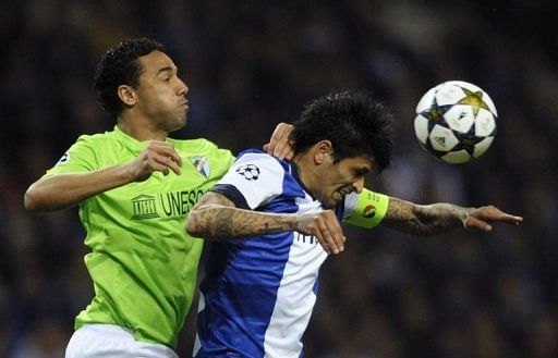 Malaga's Weligton (L) vies with Porto's Lucho Gonzales in Porto on February 19, 2013